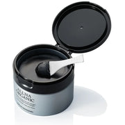 Black container of Allna Organic balm with a spoon inside on a white background